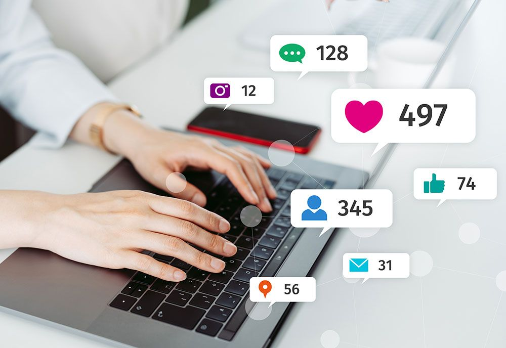 Hands typing on a laptop with social media interaction icons and numbers overlaid.