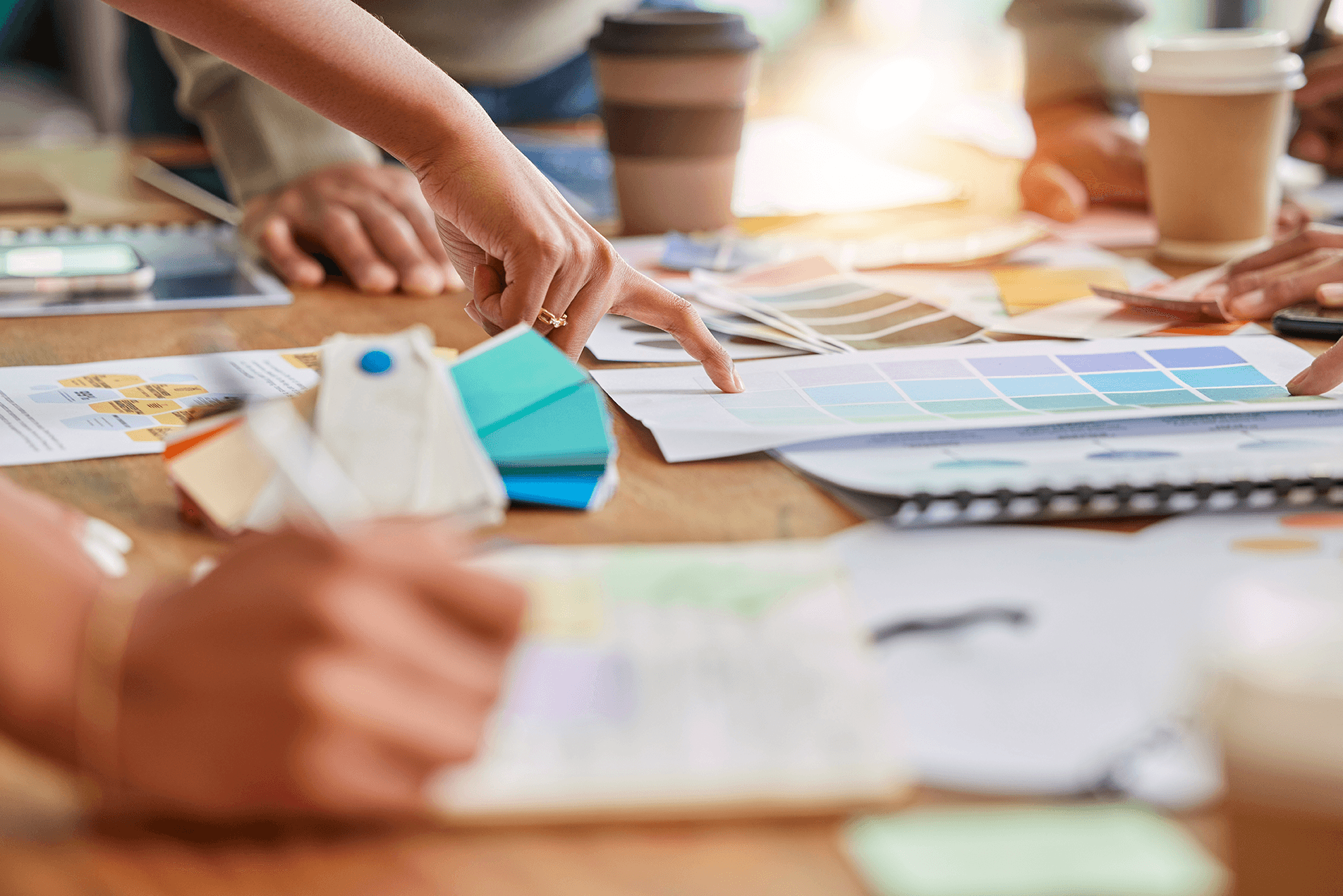 A close-up of a group reviewing design options on a table.